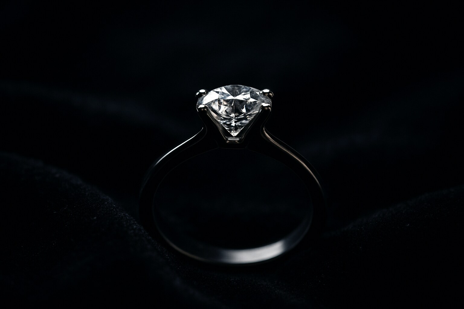 AI-generated concept image of a solitaire diamond ring standing on black velvet, the stone catching a single hard highlight in otherwise deep shadow